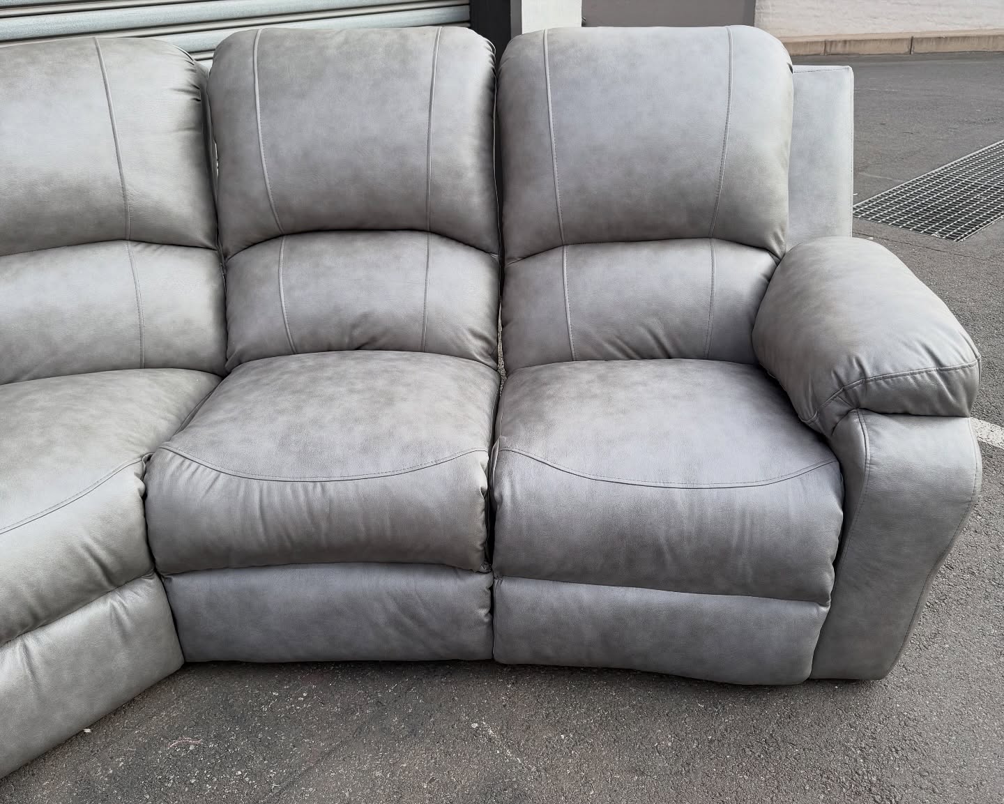 Light grey buffalo leather C-shape recliner couch by Wan-Puck Upholstery