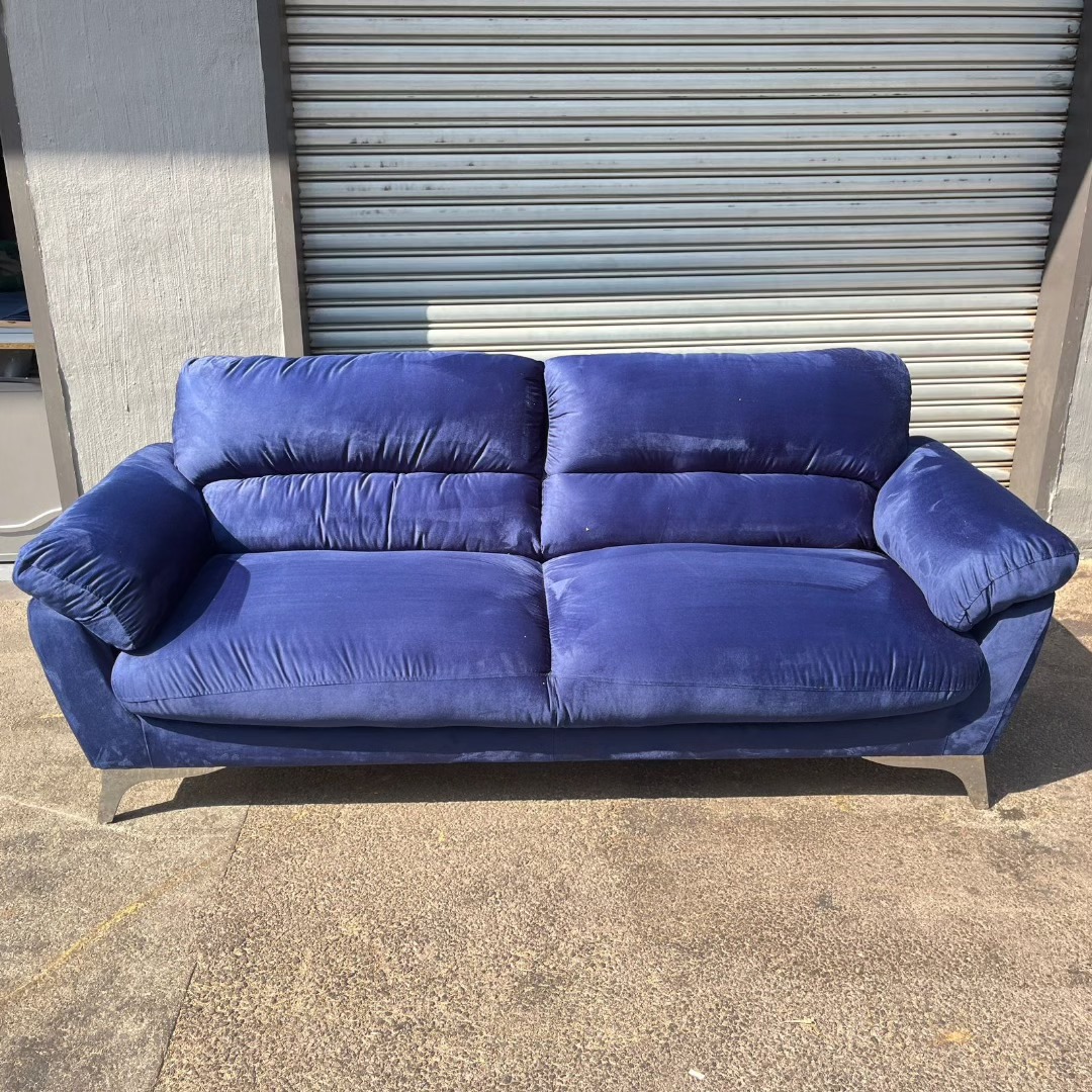 Blue velvet couch detail with chrome legs after reupholstery